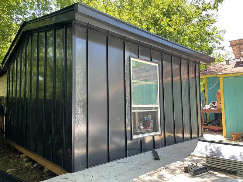 Black standing seam metal wall panels for Roof Inspection in Alma