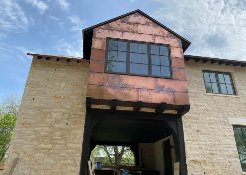 Copper metal panel facade on a stone building for Metal Roof Coating in Alma